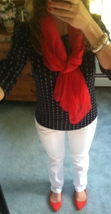 Navy patterned top, white jeans, red accents